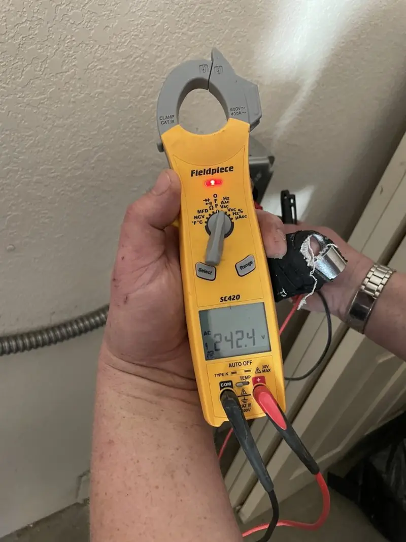 Voltage testing with clamp meter during Ceiling Fan Installation in Stratford